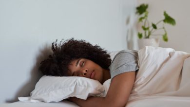 Woman sleeping in her bed at home.