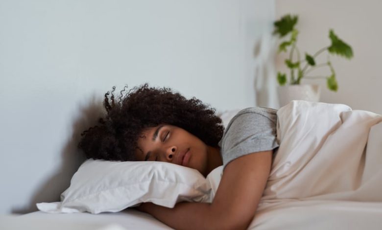 Woman sleeping in her bed at home.