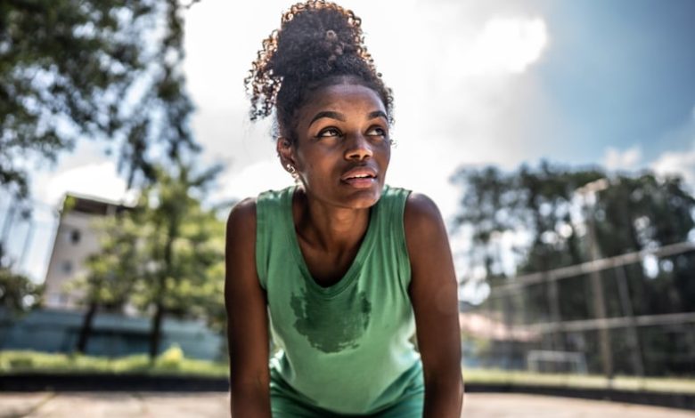 Tired young woman in a sports court