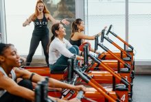 people on rowers doing the Orangetheory DriTri in a studio