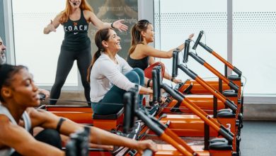 people on rowers doing the Orangetheory DriTri in a studio