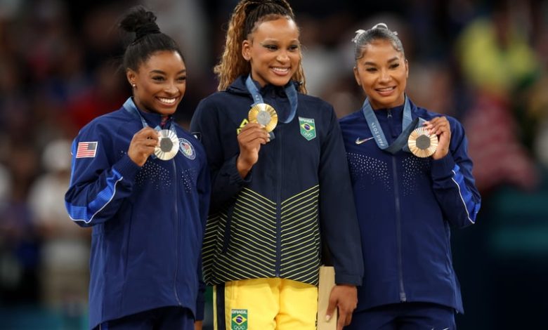 PARIS, FRANCE - AUGUST 05: Gold medalist Rebeca Andrade (C) of Team Brazil, silver medalist Simone Biles (L) of Team United States and bronze medalist Jordan Chiles (R) of Team United States pose on the podium at the Artistic Gymnastics Women's Floor Exer