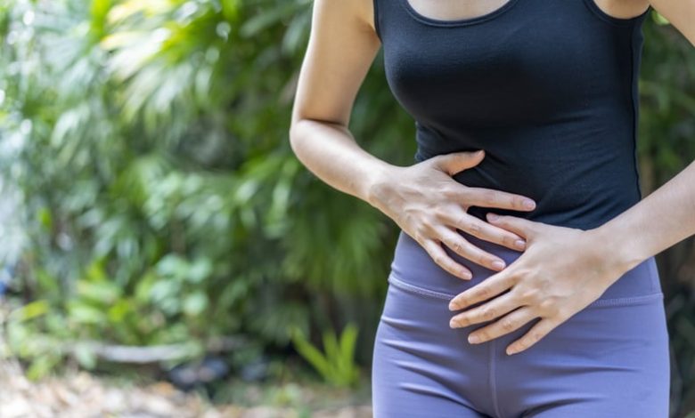 woman holding her stomach because she's bloated after a workout