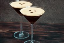 Two espresso martini cocktails garnished with coffee beans.
